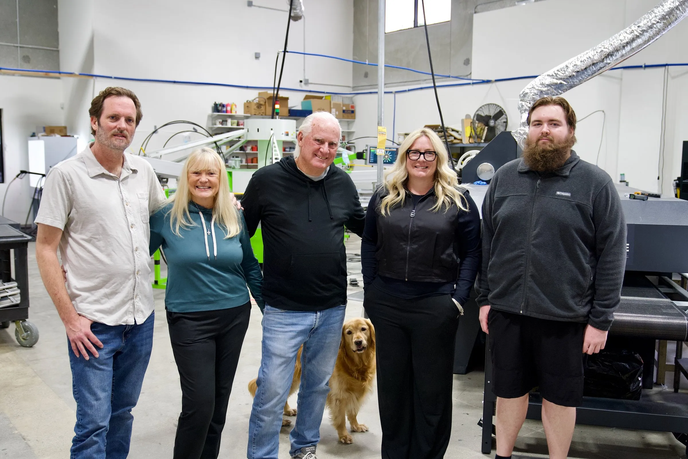 The Lamb family and team at the press in the San Marcos shop, with the shop dog.
