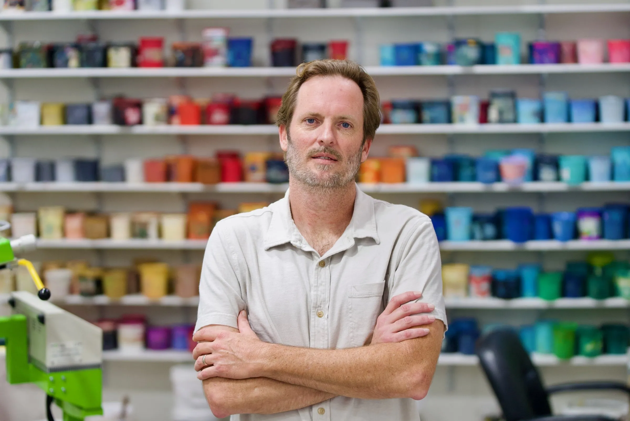 Ryan Lamb in front of the shop's ink wall