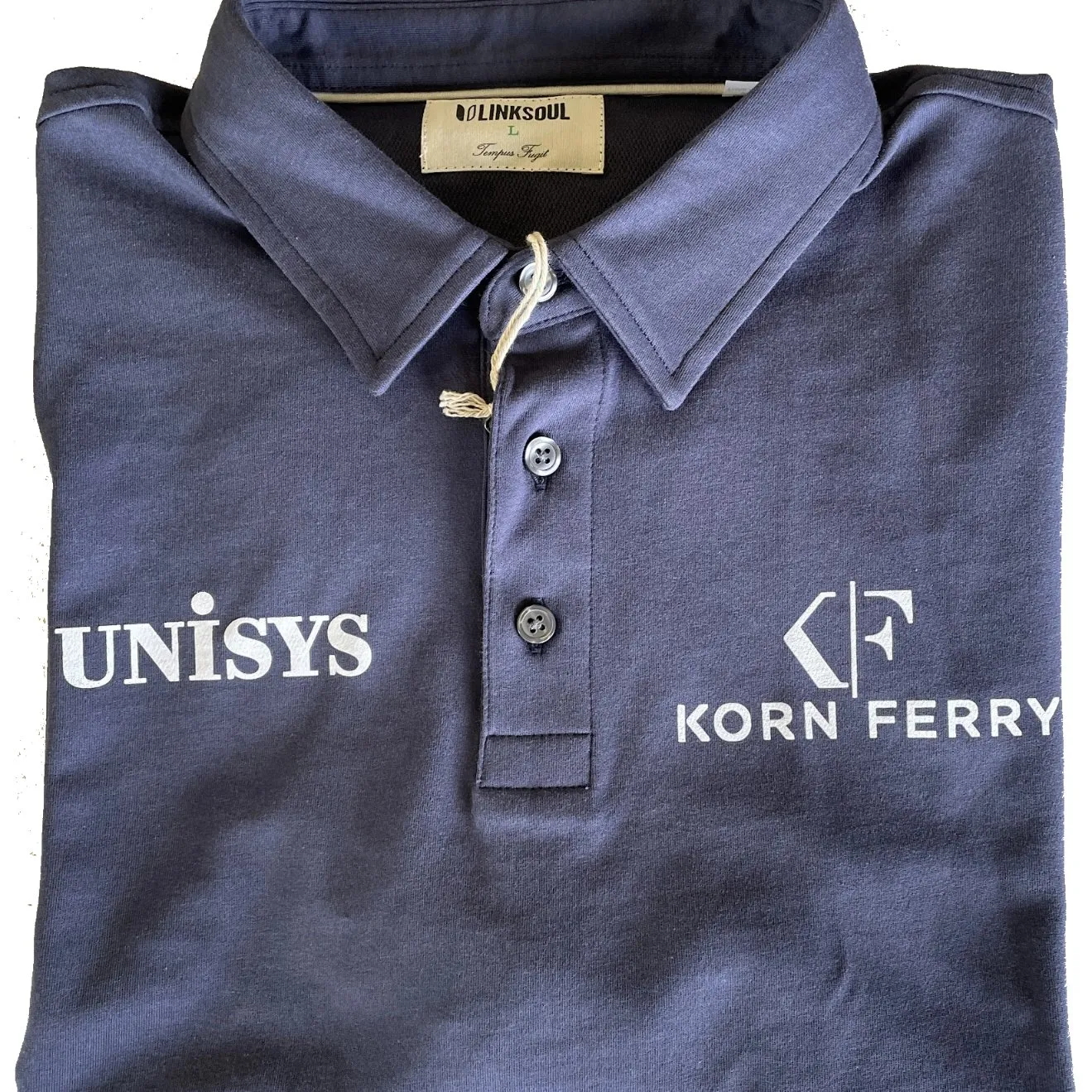 Folded navy polo with a white logo print on each side of the chest